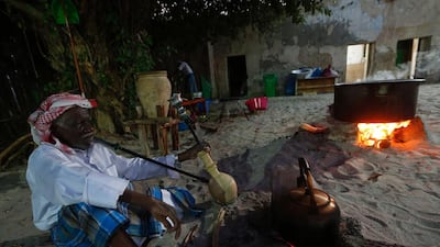 An Emirati man prepares traditional food.