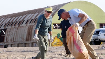US Ambassador to Kuwait Alina L. Romanowski (L) takes part in a clean-up campaign at Asheraj beach, 60Km north of Kuwait city, to mark World Clean Up Day, on September 18, 2021. (Photo by Yasser Al-Zayyat / AFP)
