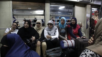 Egyptian women listen to a lecture by a female police officer on how to avoid sexual harassment and how to take care of children, in Al Shohadaa metro station.
