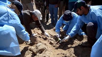 Members from the Iraqi forensic team search exhume the bodies of soldiers killed by ISIL from a mass grave in the presidential compound of the former president Saddam Hussein in Tikrit on April 6, 2015. About 1,700 Shiite soldiers from Camp Speicher were murdered by ISIL in June when the militant group overran Tikrit. Reuters