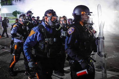 Police face protesters outside Delaney Hall in Newark, which is being used as an ICE detention centre. AFP