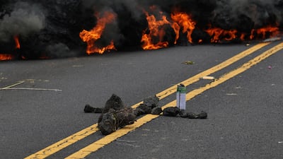 Lava burns across a road as an offering to the volcano goddess lies in the foreground in the Leilani Estates subdivision near Pahoa, Hawaii. Caleb Jones / AP Photo