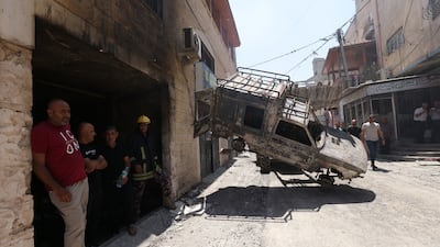 A damaged vehicle left in the street in Jenin. EPA