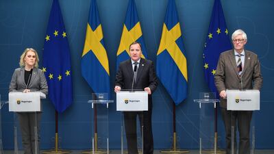 Sweden's Prime Minister Stefan Lofven (centre) attends a press conference on the emergency pandemic law passed on January 8, 2021 in Stockholm giving the government new powers to curb the spread of Covid-19 AFP