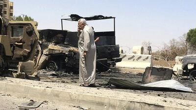 A man looks at burnt vehicles belonging to Iraqi security forces a day after radical Sunni Muslim insurgents seized control of city of Mosul on June 11, 2014. Reuters
