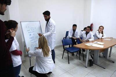 Syrian doctors attend a training course at a Migrant Health Centre in Ankara on February 22, 2018. Adem Altan / AFP