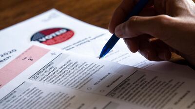 A voter fills an official mail-in ballot answering the proposition 22 question in Los Angeles, California. EPA