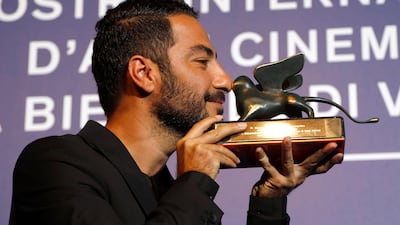 Navid Mohammadzadeh holds the Orizzonti Special Prize for best actor for No Date, No Signature during the awards photo call at the 74th Venice Film Festival. Domenico Stinellis / AP photo