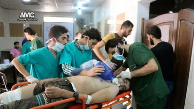 Medical staff treat a man suffering from breathing difficulties inside a hospital in Aleppo, Syria after a chemical attack. Aleppo Media Center via AP