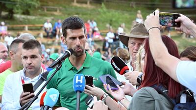 Serbian tennis player Novak Djokovic speaks to reporters after an exhibition match, organised to mark the opening of a tennis court at the "Archaeological park of the Bosnian pyramid" near Visoko, north of Sarajevo, on July 13, 2022. AFP