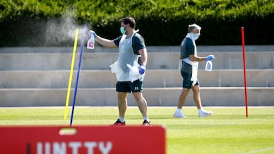 Fitness Coach Steve Wright cleans down equipment after use as Southampton players return to training. Getty