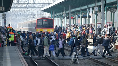 People wearing protective face masks make their way during rush hour at a train station in Jakarta, Indonesia, . Reuters