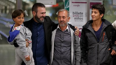 Syrian refugee Osama Abdul Mohsen, second right, with his sons Mohammed, 18, and Zaid, 7, after arriving Atocha train station in Madrid, Spain. Pablo Blazquez Dominguez / Getty Images