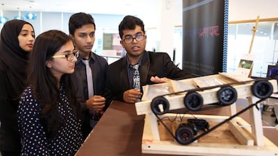 From left, Mahnoor Irfan, Muskaan Fatnani, Akshar Patel and Calvin Francis from The Winchester School, Jebel Ali, demonstrate the automated thermal regulating system they invented at the Arab Innovation Centre for Education event in Dubai. Pawan Singh / The National