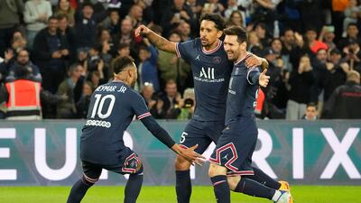 PSG's Neymar, left, and Marquinhos, center, celebrate as Lionel Messi, right, scored the opening goal during the French League One soccer match between Paris Saint Germain and Lens at Parc des Princes stadium in Paris, Saturday, April 23, 2022. (AP Photo / Michel Euler)