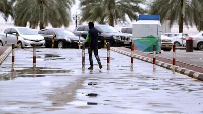 A man makes his way through inclement weather Sharjah. Chris Whiteoak/The National