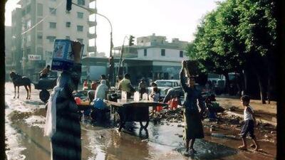 A group of women carry supplies down a street August 8, 1982 in Beirut, Lebanon. Roland Neveu / Liaison