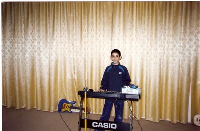 Hamad Altaee with one of the first keyboards his father ever bought him. He is a self-taught musician. CREDIT: Courtesy Hamad Altaee