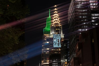 Activists project protest messages against Jeff Bezos and Lauren Sanchez onto the Chrysler Building in New York, ahead of the Met Gala. Reuters