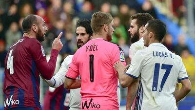 Real Madrid’s Nacho Fernandez, right, speaks with Eibar’s Ivan Ramis, left. Alvaro Barrientos / AP Photo