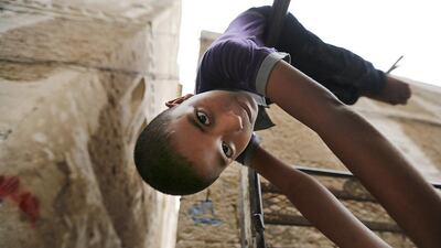 A boy plays on the back of a pick-up truck in Yemen's capital Sanaa April 18, 2016. REUTERS/Khaled Abdullah