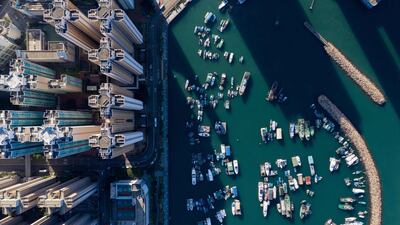 Boats moored at a typhoon shelter next to residential buildings in Hong Kong.