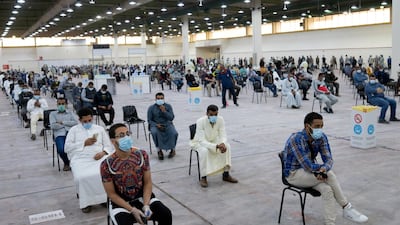 Expatriates wait for mandatory coronavirus testing in a makeshift testing centre in Mishref, Kuwait. REUTERS