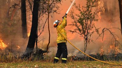 A firefighter conducts back-burning measures to secure residential areas from encroaching bushfires in the Central Coast, some 90-110 kilometres north of Sydney. AFP