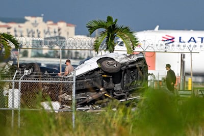 Cars were damaged after the cargo plane struck vehicles parked beyond the runway at the airport. AFP