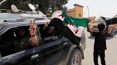 Members of Turkey-backed Syrian National Army (former FSA) flash the V-sign as they drive back to Turkey after they went in for some time on inspection according to the Turkish police entourage in the same area at the border between Turkey and Syria, in Akcakale, Sanliurfa province, southeastern Turkey. Turkish President Recep Tayyip Erdogan has long threatened to send troops into northeastern Syria to clear the border region of Syrian Kurdish fighters whom Turkey considers a serious security threat. AP Photo