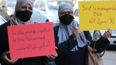 Muslim women hold up placards during a protest outside the French embassy in the Jordanian capital Amman against French President Emmanuel Macron's defence of cartoons depicting the Prophet Mohammed. Slogan in French and Arabic on yellow placard reads: "Anyone but the prophet". Calls to boycott French goods are growing in the Arab world and beyond, after Macron criticised Islamists and vowed not to "give up cartoons" depicting the Prophet Mohammed in recent comments that came in response to the beheading of a teacher, Samuel Paty, outside his school in a suburb outside Paris earlier this month, after he had shown cartoons of the Prophet Mohammed during a class he was leading on free speech. AFP