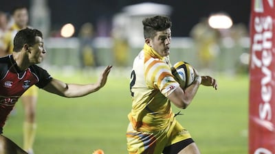 Miles Walby, right, and his Dubai Hurricane teammates were able to elude the grasp of the Dubai Exiles with a 46-20 win. Antonie Robertson / The National