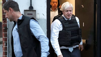 Britain's Prime Minister Boris Johnson reacts as he leaves a property following a drugs related raid by Metropolitan Police officers, in London, on August 31, 2022, as part of a visit to a police station. (Photo by PETER NICHOLLS / POOL / AFP)