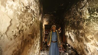 A follower of the Shi’ite Houthi movement inspects a house belonging to an officer of the Yemen army, which was damaged during clashes with army soldiers, in Wadi Dhahr suburb of the Yemeni capital of Sanaa. At least 20 people were killed when Shi’ite Muslim rebels clashed with army soldiers and allied tribesmen in an outer suburb of the Yemeni capital of Sanaa, tribal and medical sources said on Wednesday. Khaled Abdullah / Reuters