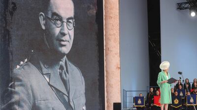 Britain's Prime Minister Theresa May speaks as she reads a letter written by Captain Skinner, during an event to commemorate the 75th anniversary of the D-Day landings, in Portsmouth. AFP