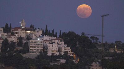The sturgeon supermoon rises above the Mount of the Olives in Jerusalem. AFP