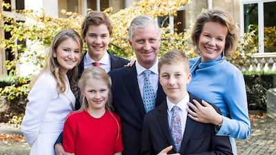 King Philippe of Belgium smiles next to Queen Mathilde of Belgium for their Christmas photo, alongside their daughters Princess Elisabeth, Duchess of Brabant, and Princess Eleonore, and sons, Prince Gabriel and Emmanuel. Instagram/ belgianroyalpalace