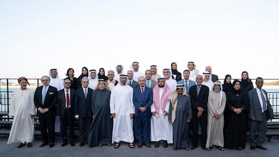 Sheikh Mohamed bin Zayed stands for a photograph with members of Emirates Writers Union, during a Sea Palace barza. Mohamed Al Hammadi / Ministry of Presidential Affairs