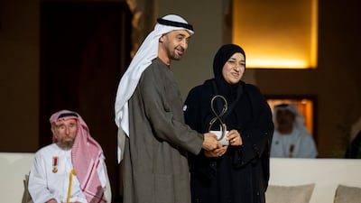 Sheikh Mohamed presents an Abu Dhabi Award to Moza Al Hafiti