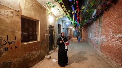 Hajja Dalal, a 46-year-old Mesaharati, beats a drum to wake up Muslims to have the predawn meal before they start their long-day fast during Ramadan, at Maadi neighbourhood in Cairo, Egypt. Reuters