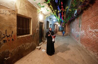 Hajja Dalal, a 46-year-old Mesaharati, beats a drum to wake up Muslims to have the predawn meal before they start their long-day fast during Ramadan, at Maadi neighbourhood in Cairo, Egypt. Reuters