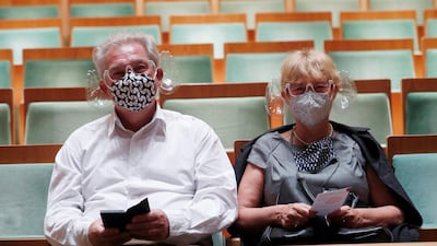 A couple wears orchestra conductor Ivan Fischer's acoustic mask at the Mupa Budapest. Reuters