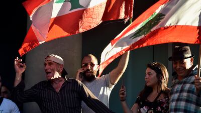 Lebanese protesters shout slogans during a demonstration against the high cost of telecoms, the high cost of living and the low purchasing power of the Lebanese pound in front of the MTC Touch communications building in Beirut, Lebanon. EPA