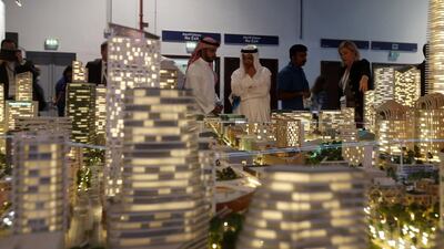Visitors gather near a scaled version of a property project durign the Cityscape Global 2016 show in Dubai last month. Karim Sahib / AFP