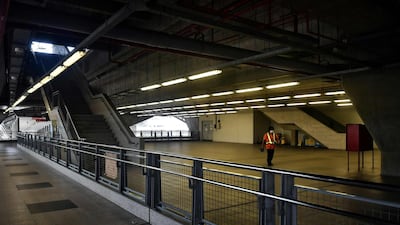 A cleaner walks through an empty Airport Link railway station, amid travel restrictions to contain the spread of the COVID-19 coronavirus, in Bangkok. AFP