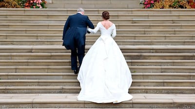 Britain's Princess Eugenie of York (R) arrives accompanied by her father Prince Andrew, Duke of York, (L) arrives to attend the wedding to Jack Brooksbank at St George's Chapel, Windsor Castle, in Windsor, on October 12, 2018. / AFP / POOL / TOBY MELVILLE