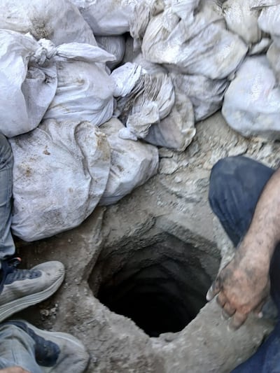 The rainwater drainage pit where authorities found a large amount of money, in Iraq. Photo: Supreme Judicial Council