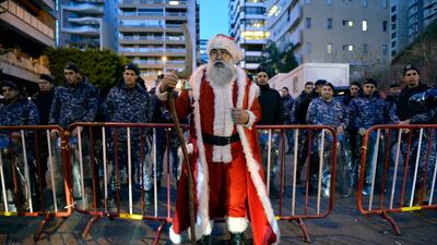 A demonstrator dressed in a Santa Claus costume stands outside the Beirut home of Hassan Diab on December 24 in protest at his nomination as Prime Minister of Lebanon. Mr Diab vowed on 19 December to form a government of experts within six weeks. EPA
