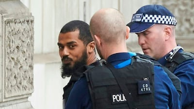 Firearms officers from the British police detain a man, later named as Khalid Mohammed Omar Ali, on Whitehall near the Houses of Parliament in central London, before being taken away by police. AFP / Niklas Hallen