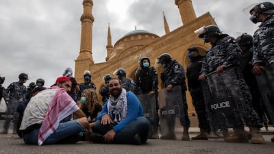 Anti-government protestor shouts slogans in front Lebanese police officers as they try to close the road in front Al-Ameen mosque during a protest against the collapsing Lebanese pound currency and the price hikes of goods, in Beirut, Lebanon. EPA
